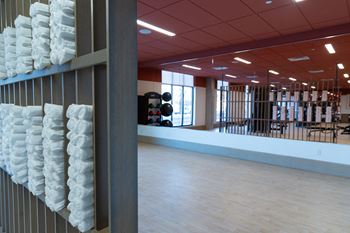 A room with a long shelf of white pillows.